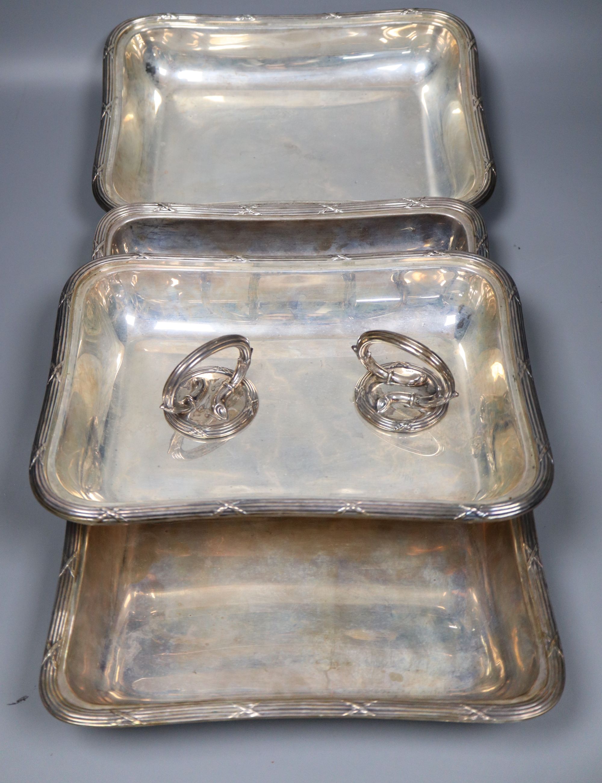 A pair of George V silver entree dishes and covers with handles and later engraved inscription, Walker & Hall, Chester, 1910/11